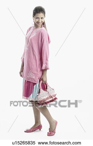 Side profile of a young woman smiling View Large Photo Image Stock Photography - Side profile of a young woman smiling. Fotosearch