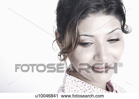 Stock Image - Young woman looking down. Fotosearch