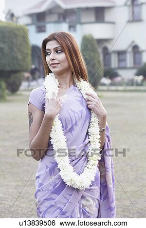 Stock Photograph - Young woman wearing a garland. Fotosearch