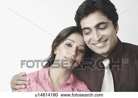 Stock Image - Close-up of a mid adult couple smiling. Fotosearch