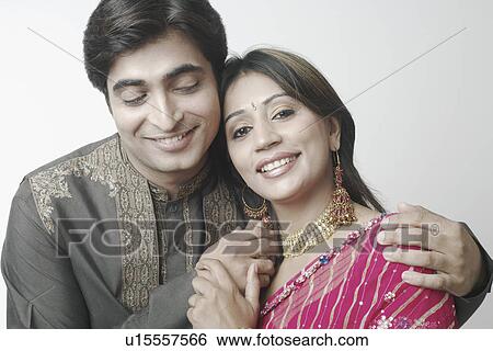 Stock Photograph - Close-up of a mid adult couple smiling. Fotosearch