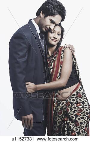 Close-up of a young couple embracing each other View Large Photo Image Stock Image - Close-up of a young couple embracing each other. Fotosearch