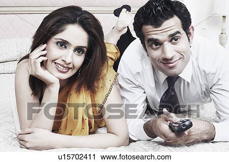 Close-up of a young couple lying on the bed View Large Photo Image Stock Image - Close-up of a young couple lying on the bed. Fotosearch