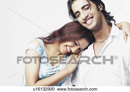Close-up of a young couple smiling View Large Photo Image Stock Image - Close-up of a young couple smiling. Fotosearch