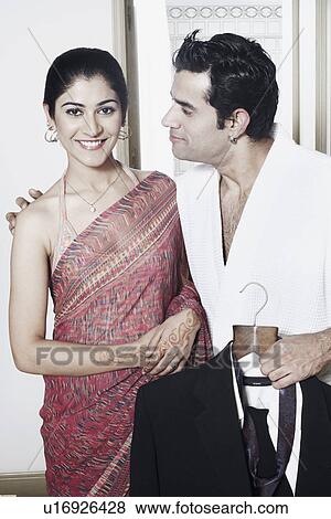 Stock Photo - Close-up of a young couple smiling. Fotosearch