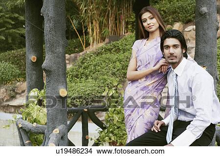 Picture - Portrait of a young couple in the garden. Fotosearch