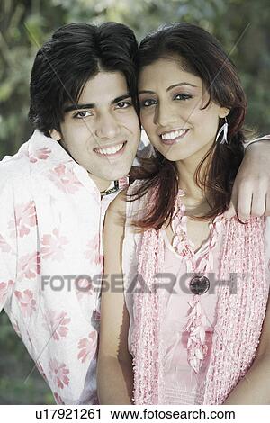 Stock Image - Portrait of a young couple smiling. Fotosearch