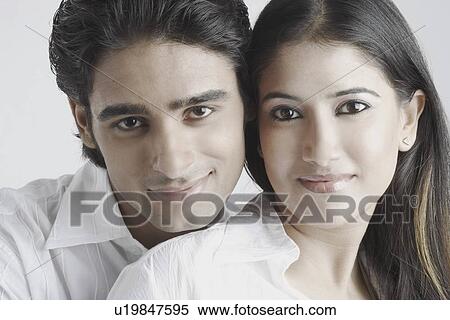 Portrait of a young couple smiling View Large Photo Image Stock Photography - Portrait of a young couple smiling. Fotosearch