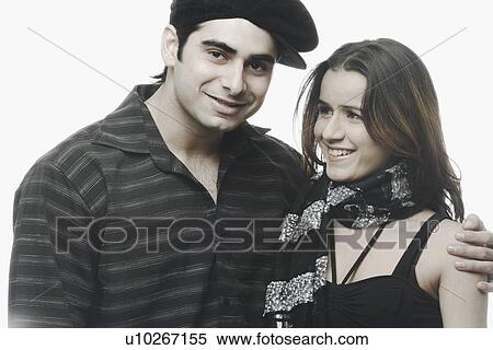 Stock Photography - Portrait of a young man with his arm around of a young woman. Fotosearch