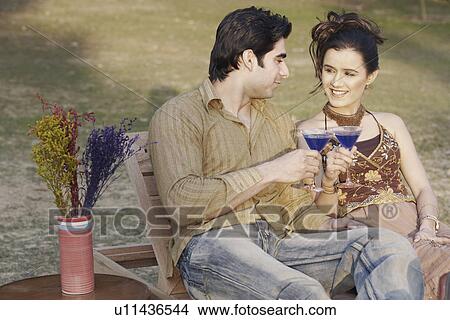 Picture - Young couple toasting cocktails. Fotosearch
