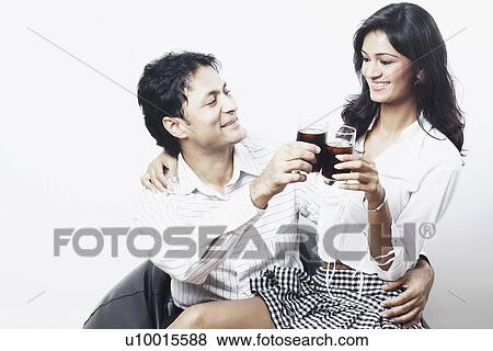 Young couple toasting with wine glasses View Large Photo Image Stock Photo - Young couple toasting with wine glasses. Fotosearch