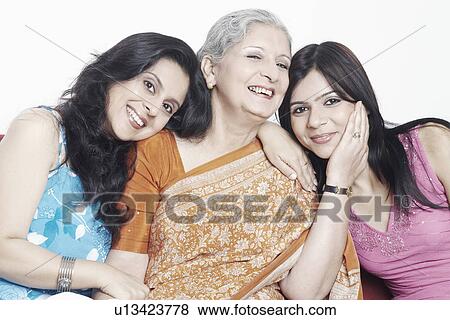 Close-up of a mother sitting with her two daughters View Large Photo Image Stock Photo - Close-up of a mother sitting with her two daughters. Fotosearch