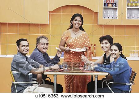Portrait of a family sitting at the dining table View Large Photo Image Stock Image - Portrait of a family sitting at the dining table. Fotosearch