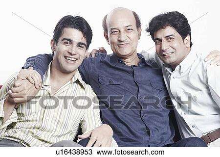 Stock Image - Portrait of a father sitting with his two sons. Fotosearch