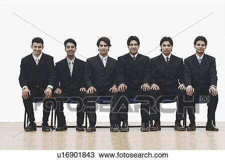 Portrait of a group of young men sitting on chairs View Large Photo Image Stock Image - Portrait of a group of young men sitting on chairs. Fotosearch