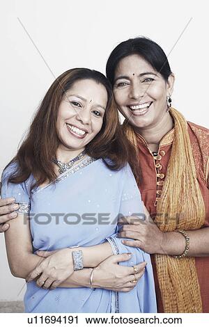 Portrait of a mature woman and a mid adult woman smiling View Large Photo Image Stock Image - Portrait of a mature woman and a mid adult woman smiling. Fotosearch