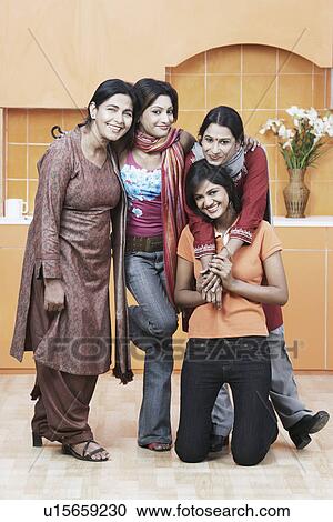 Stock Image - Portrait of a mother and her three daughters smiling. Fotosearch