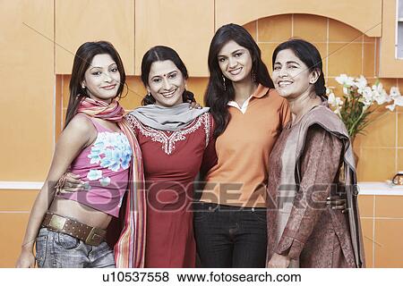 Portrait of a mother and her three daughters smiling View Large Photo Image Stock Photo - Portrait of a mother and her three daughters smiling. Fotosearch