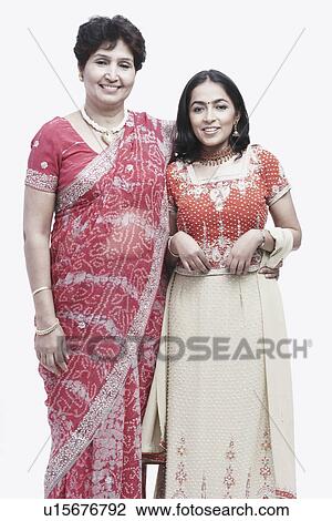 Stock Image - Portrait of a mother standing with her daughter. Fotosearch
