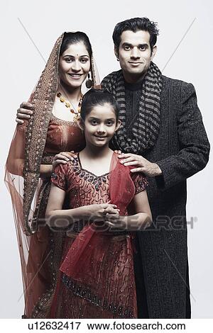 Portrait of a newlywed couple standing with a girl View Large Photo Image Stock Photo - Portrait of a newlywed couple standing with a girl. Fotosearch