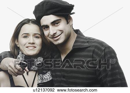 Stock Image - Portrait of a young couple holding each other. Fotosearch
