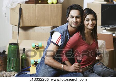Portrait of a young couple holding wineglasses View Large Photo Image Stock Photography - Portrait of a young couple holding wineglasses. Fotosearch