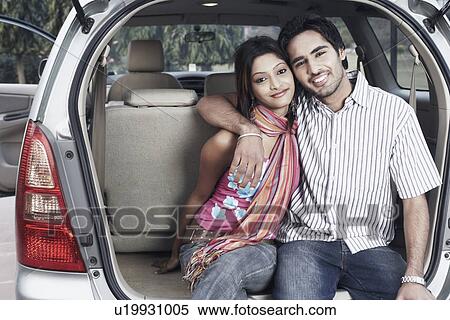 Portrait of a young couple sitting in a car View Large Photo Image Stock Photography - Portrait of a young couple sitting in a car. Fotosearch