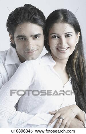 Stock Photography - Portrait of a young couple smiling. Fotosearch