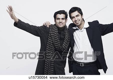 Portrait of two young men standing with their arms around each other View Large Photo Image Picture - Portrait of two young men standing with their arms around each other. Fotosearch