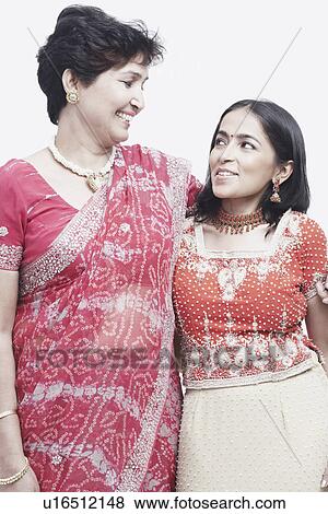 Stock Photo - Close-up of a mother and her daughter looking at each other. Fotosearch