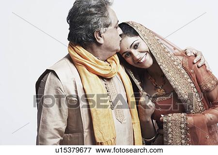 Portrait of a father kissing his daughter View Large Photo Image Stock Photo - Portrait of a father kissing his daughter. Fotosearch