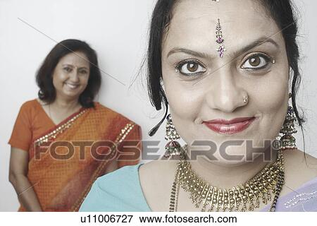 Stock Photo - Portrait of a mature woman with another mature woman standing behind her. Fotosearch
