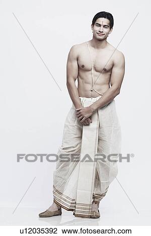 Stock Image - Portrait of a young man in traditional clothing. Fotosearch