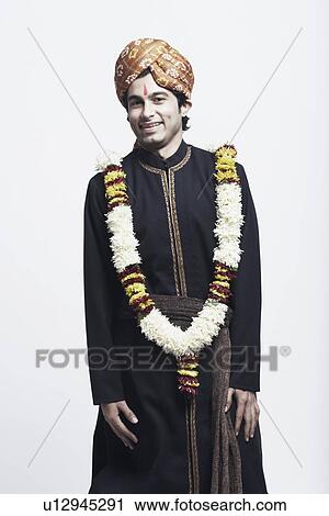 Portrait of a young man wearing a traditional wedding outfit View Large Photo Image Stock Image - Portrait of a young man wearing a traditional wedding outfit. Fotosearch