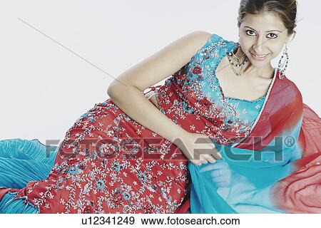 Portrait of a young woman smiling View Large Photo Image Stock Photo - Portrait of a young woman smiling. Fotosearch