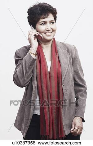 Close-up of a mature woman talking on a mobile phone View Large Photo Image Stock Photograph - Close-up of a mature woman talking on a mobile phone. Fotosearch