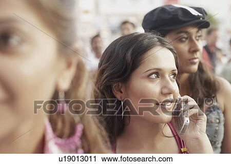 Stock Image - Close-up of a young woman talking on a mobile phone. Fotosearch
