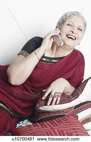 Stock Image - Mature woman using a mobile phone. Fotosearch