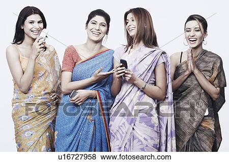 Stock Photo - Close-up of four young women holding mobile phones. Fotosearch