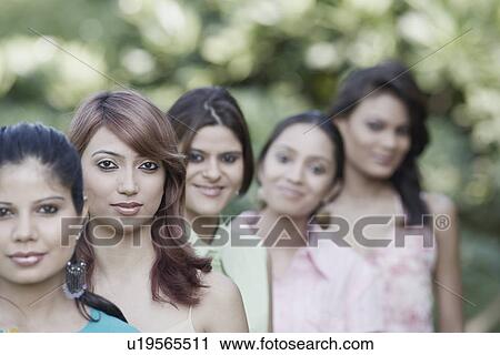 Stock Image - Five women standing in a row. Fotosearch