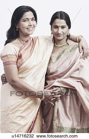 Portrait of a mature woman standing with a mid adult woman View Large Photo Image Stock Image - Portrait of a mature woman standing with a mid adult woman. Fotosearch