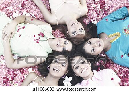 Portrait of a teenage girl and four young women lying on their back View Large Photo Image Stock Image - Portrait of a teenage girl and four young women lying on their back. Fotosearch