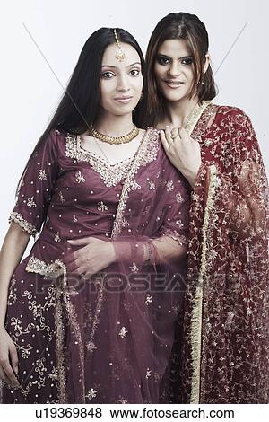 Portrait of a teenage girl standing with a young woman View Large Photo Image Stock Photo - Portrait of a teenage girl standing with a young woman. Fotosearch