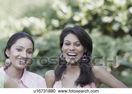 Portrait of a young woman and a teenage girl smiling View Large Photo Image Stock Image - Portrait of a young woman and a teenage girl smiling. Fotosearch