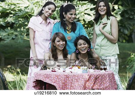 Portrait of four young women and a teenage girl laughing View Large Photo Image Stock Image - Portrait of four young women and a teenage girl laughing. Fotosearch