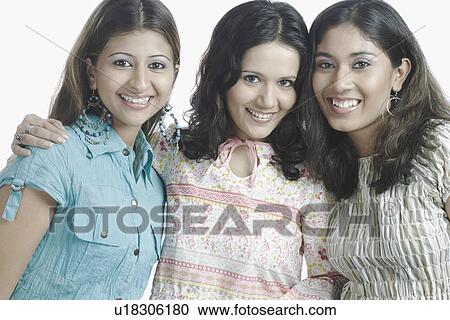 Stock Image - Portrait of three young women smiling. Fotosearch