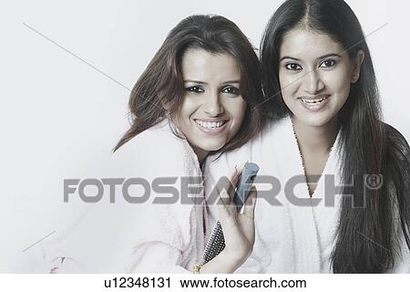 Stock Image - Portrait of two young women smiling. Fotosearch