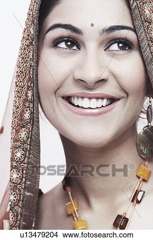 Picture - Close-up of a young woman in traditional clothing smiling. Fotosearch