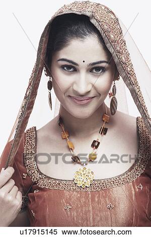 Portrait of a young woman in traditional clothing View Large Photo Image Stock Photography - Portrait of a young woman in traditional clothing. Fotosearch