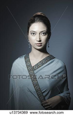 Stock Photo - Portrait of a young woman wearing a sari. Fotosearch